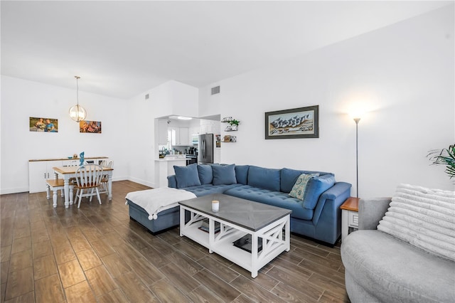 360 71st Ave, St Pete Beach, FL 33706 - living room featuring dark wood finished floors and vaulted ceiling