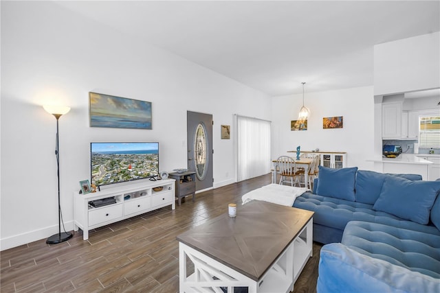 360 71st Ave, St Pete Beach, FL 33706 - living room with dark wood-style floors and baseboards