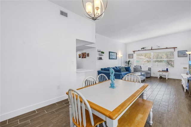 360 71st Ave, St Pete Beach, FL 33706 - dining space with dark wood-style floors and a chandelier