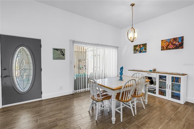 360 71st Ave, St Pete Beach, FL 33706 - dining room with healthy amount of natural light, wood finished floors, and a chandelier