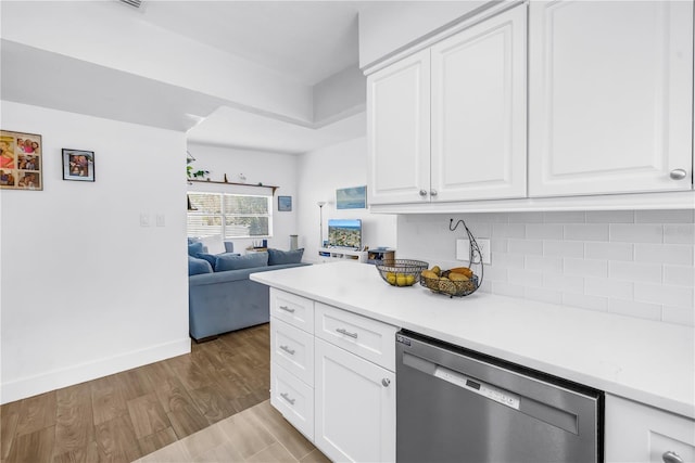 360 71st Ave, St Pete Beach, FL 33706 - kitchen featuring dishwasher, open floor plan, decorative backsplash, light countertops, and white cabinets