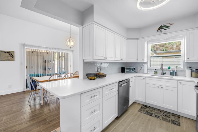 360 71st Ave, St Pete Beach, FL 33706 - kitchen with light wood-style flooring, a peninsula, white cabinets, and dishwasher