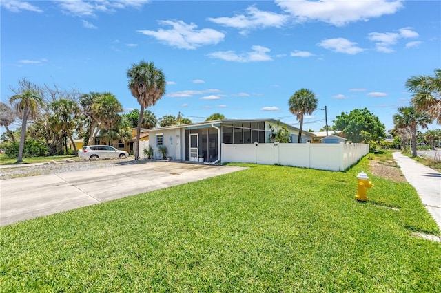 360 71st Ave, St Pete Beach, FL 33706 - view of front facade featuring a sunroom and driveway