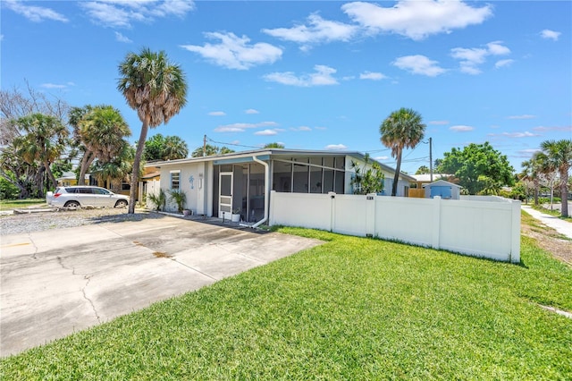 360 71st Ave, St Pete Beach, FL 33706 - view of yard featuring a sunroom and driveway