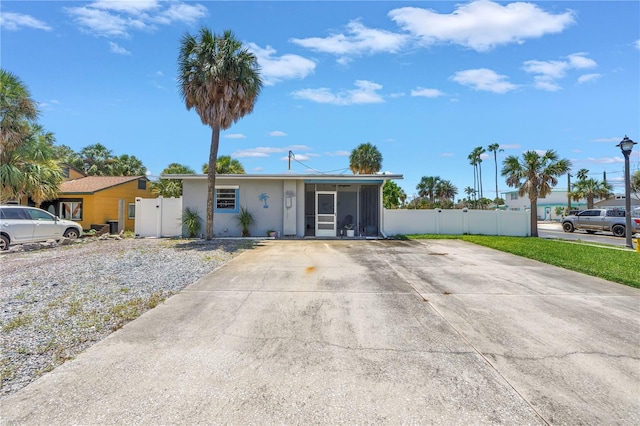 360 71st Ave, St Pete Beach, FL 33706 - single story home featuring a gate, a sunroom, and stucco siding