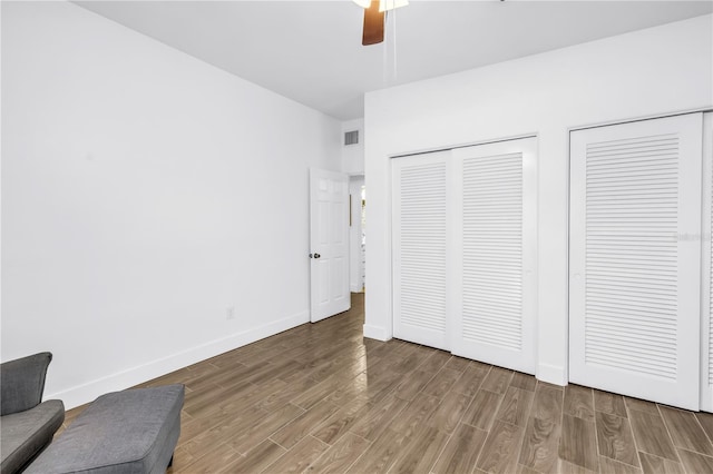 360 71st Ave, St Pete Beach, FL 33706 - bedroom with wood finished floors, two closets, and ceiling fan