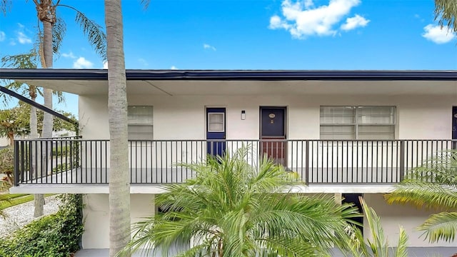 1146 King Arthur Ct Unit 114, Dunedin, FL 34698 - view of exterior entry with stucco siding