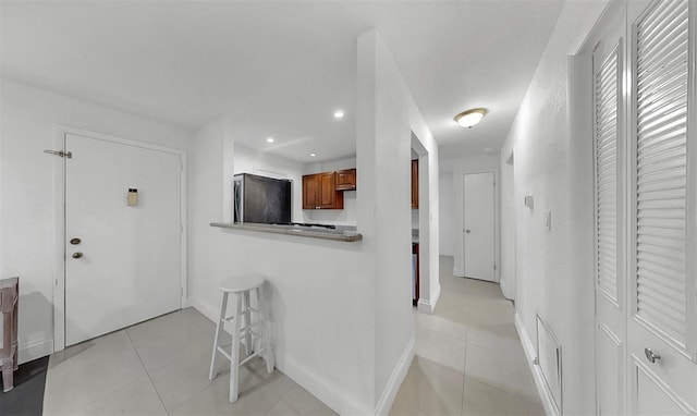 1146 King Arthur Ct Unit 114, Dunedin, FL 34698 - hall with light tile patterned floors and recessed lighting