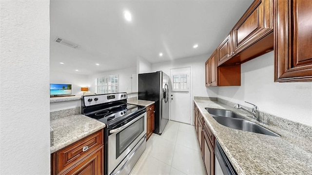 1146 King Arthur Ct Unit 114, Dunedin, FL 34698 - kitchen with appliances with stainless steel finishes, plenty of natural light, recessed lighting, light tile patterned floors, and light stone counters