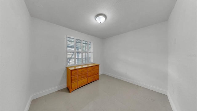 1146 King Arthur Ct Unit 114, Dunedin, FL 34698 - unfurnished bedroom featuring baseboards