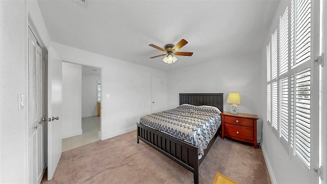 1146 King Arthur Ct Unit 114, Dunedin, FL 34698 - carpeted bedroom featuring multiple windows and ceiling fan