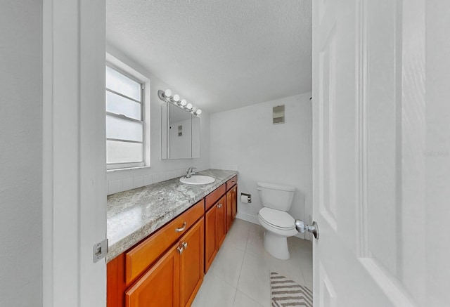 1146 King Arthur Ct Unit 114, Dunedin, FL 34698 - bathroom with vanity, a textured ceiling, and tile patterned floors
