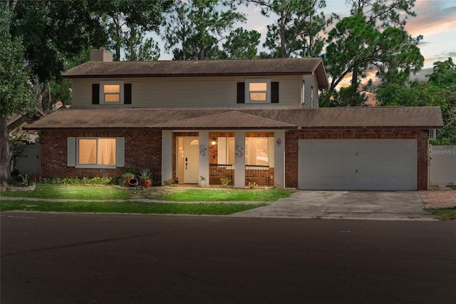 traditional-style home with brick siding, concrete driveway, an attached garage, a chimney, and a porch