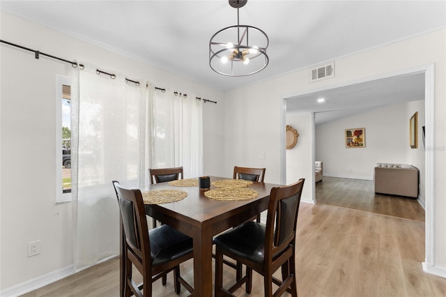 dining room with a chandelier and light wood-style floors