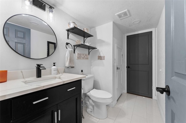 bathroom featuring vanity, a textured ceiling, and tile patterned floors