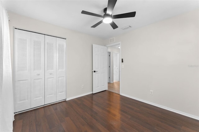 unfurnished bedroom with wood finished floors, a closet, and a ceiling fan
