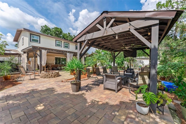 view of patio / terrace with a gazebo and an outdoor living space with a fire pit