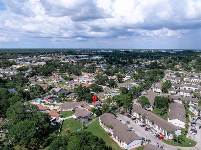 aerial view of property and surrounding area featuring nearby suburban area