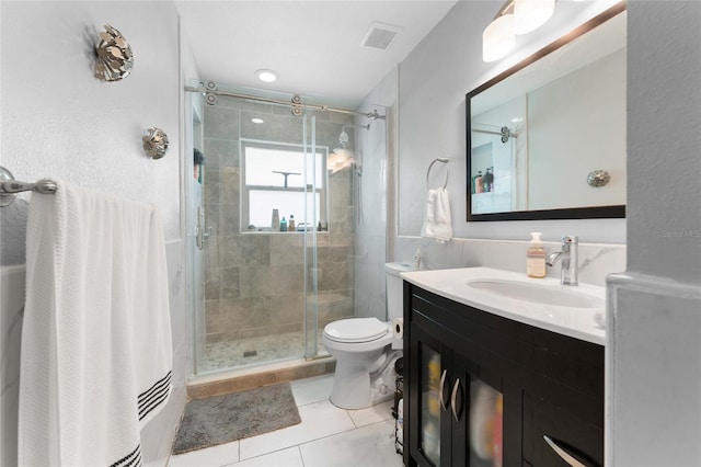 full bath featuring vanity, tile patterned floors, and a stall shower