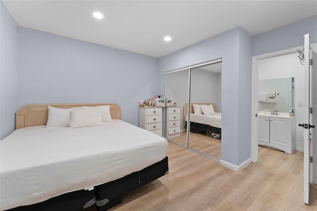 bedroom with light wood finished floors, a closet, and recessed lighting