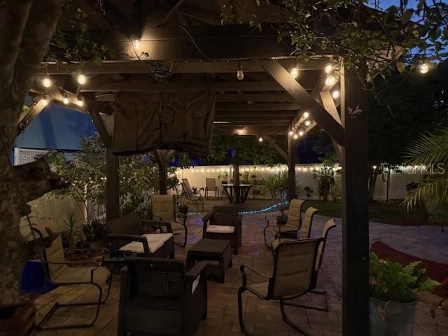 patio at night with an outdoor living space and a patio
