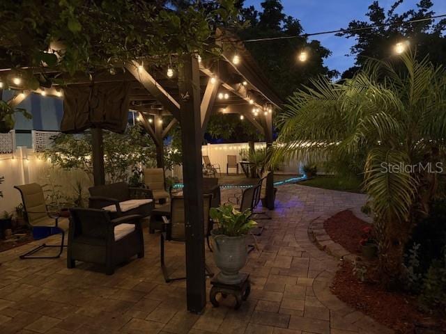 patio at night featuring a patio area