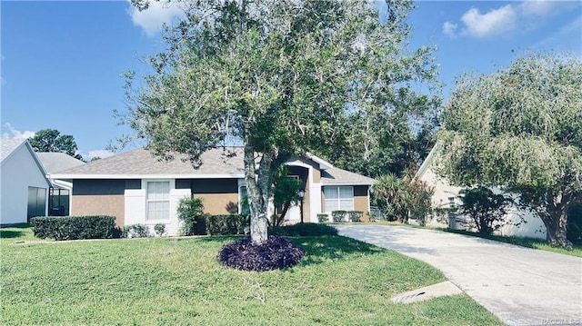 4175 N Stewart Way, Beverly Hills, FL 34465 - ranch-style house with concrete driveway, a front lawn, and stucco siding