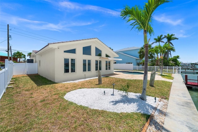 600 115th Ave, Treasure Island, FL 33706 - rear view of property with stucco siding, a fenced backyard, and a patio