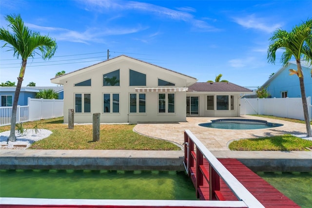 600 115th Ave, Treasure Island, FL 33706 - rear view of property featuring a fenced backyard, stucco siding, and a patio