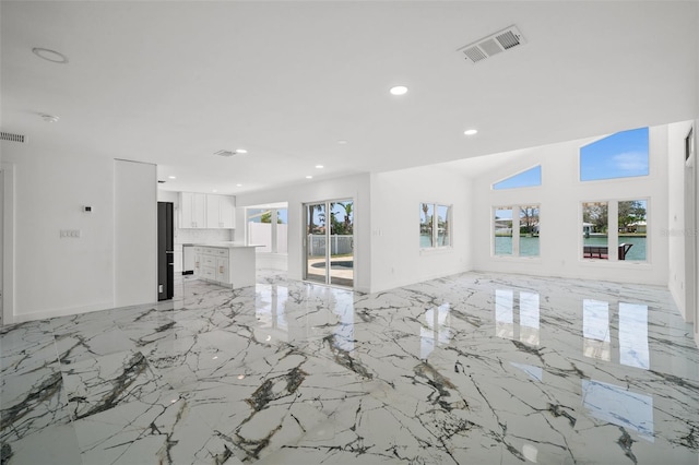 600 115th Ave, Treasure Island, FL 33706 - unfurnished living room featuring recessed lighting and light marble finish floors