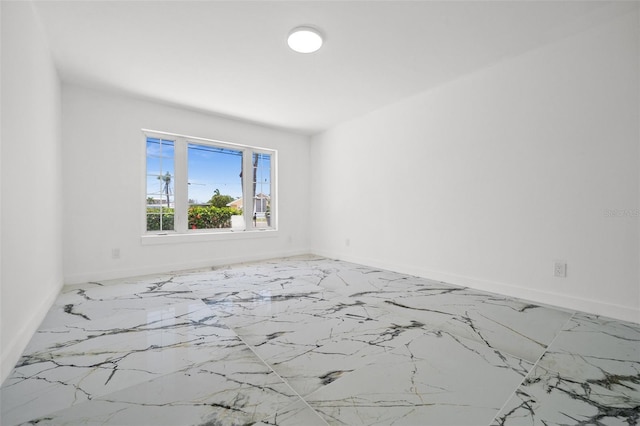 600 115th Ave, Treasure Island, FL 33706 - unfurnished room featuring baseboards and marble finish flooring