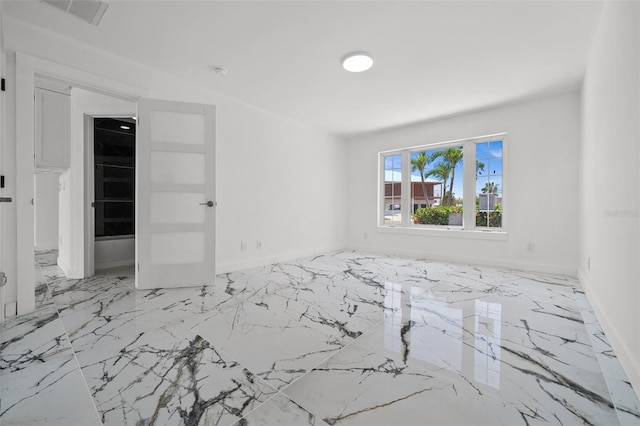 600 115th Ave, Treasure Island, FL 33706 - spare room with marble tiled flooring and baseboards