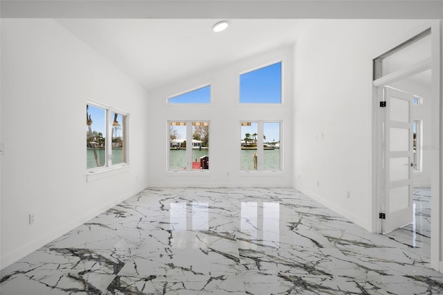 600 115th Ave, Treasure Island, FL 33706 - spare room with light marble finish floors, recessed lighting, a water view, and high vaulted ceiling