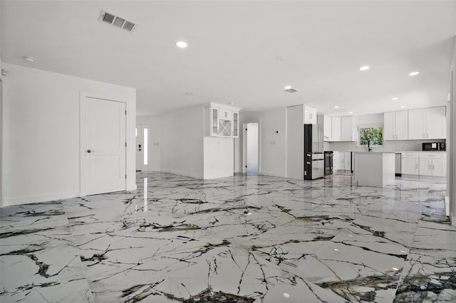 600 115th Ave, Treasure Island, FL 33706 - living room with recessed lighting and light marble finish floors