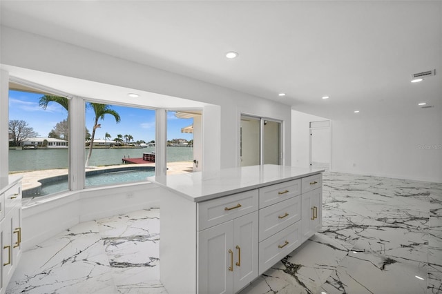 600 115th Ave, Treasure Island, FL 33706 - bathroom featuring recessed lighting, vanity, a water view, and marble tiled floors