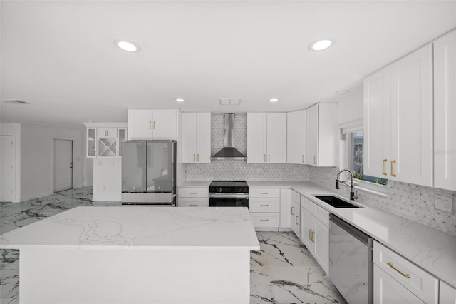 600 115th Ave, Treasure Island, FL 33706 - kitchen with appliances with stainless steel finishes, wall chimney range hood, light marble finish flooring, recessed lighting, and tasteful backsplash