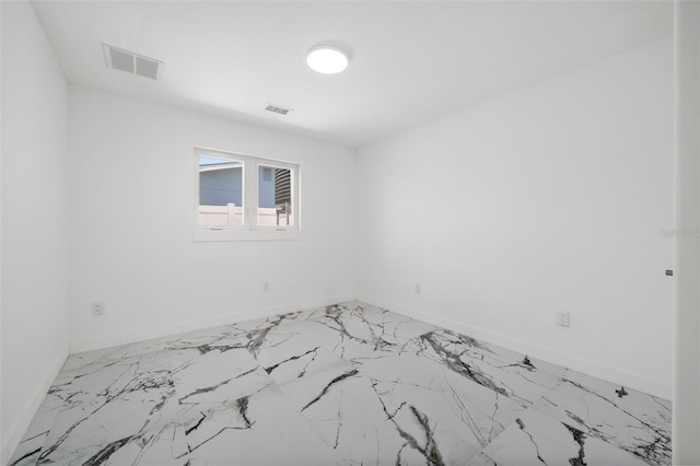600 115th Ave, Treasure Island, FL 33706 - spare room featuring light marble finish flooring