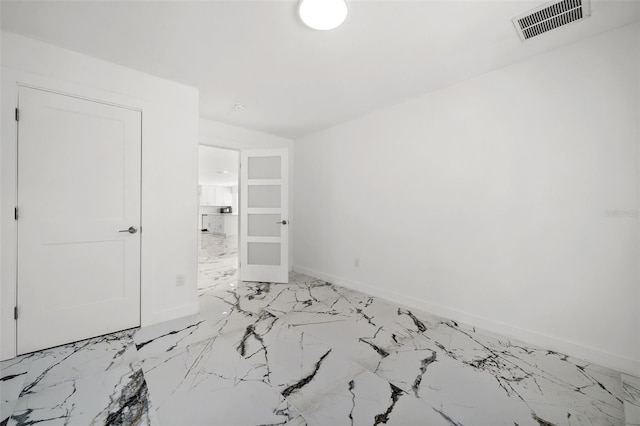 600 115th Ave, Treasure Island, FL 33706 - unfurnished bedroom with light marble finish flooring and baseboards