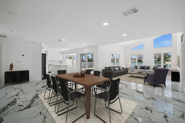 600 115th Ave, Treasure Island, FL 33706 - dining area featuring light marble finish floors and recessed lighting