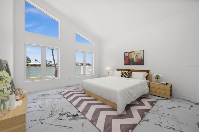 600 115th Ave, Treasure Island, FL 33706 - bedroom featuring light marble finish flooring, a water view, and high vaulted ceiling