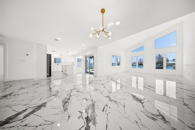 600 115th Ave, Treasure Island, FL 33706 - unfurnished living room with a chandelier, light marble finish floors, and recessed lighting