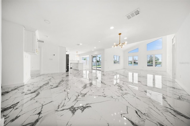 600 115th Ave, Treasure Island, FL 33706 - unfurnished living room featuring a chandelier, light marble finish floors, and recessed lighting