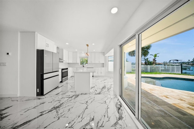 600 115th Ave, Treasure Island, FL 33706 - kitchen featuring freestanding refrigerator, electric stove, a kitchen island, white cabinetry, and recessed lighting