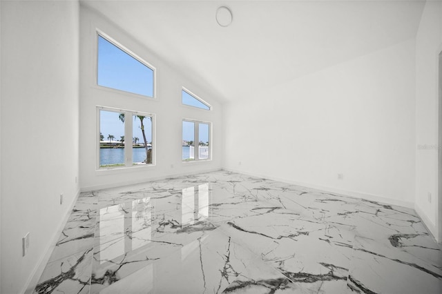 600 115th Ave, Treasure Island, FL 33706 - unfurnished room featuring marble finish flooring, vaulted ceiling, and a water view