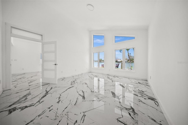 600 115th Ave, Treasure Island, FL 33706 - empty room with marble tiled floors and a towering ceiling