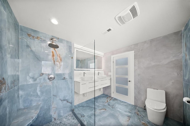 600 115th Ave, Treasure Island, FL 33706 - bathroom with tile walls, double vanity, a marble finish shower, and marble finish flooring
