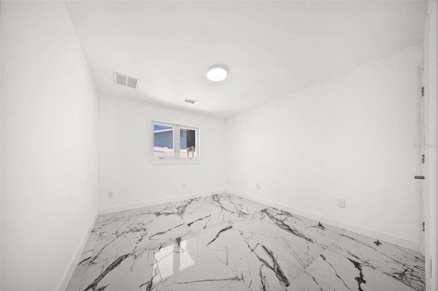 600 115th Ave, Treasure Island, FL 33706 - empty room featuring marble finish flooring and baseboards