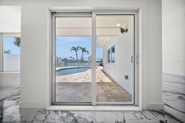 600 115th Ave, Treasure Island, FL 33706 - doorway to outside featuring marble finish floors and a water view