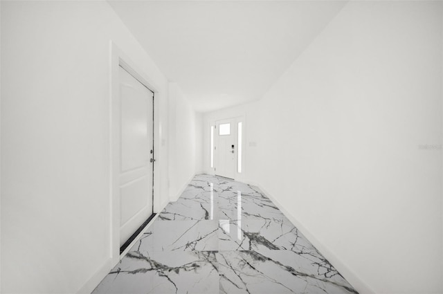 600 115th Ave, Treasure Island, FL 33706 - hall featuring light marble finish floors and baseboards