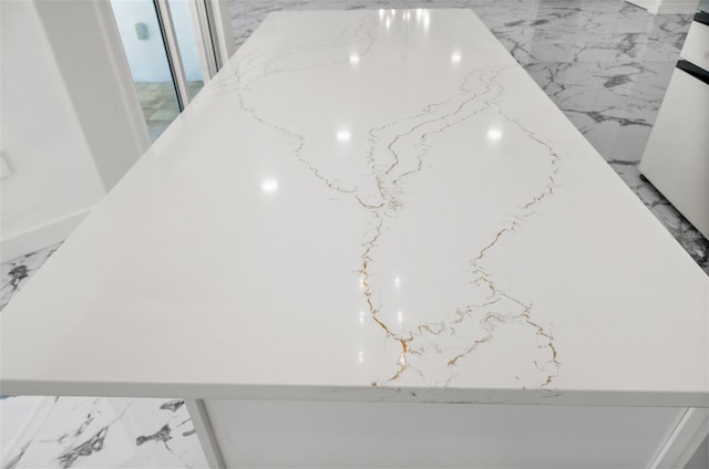 600 115th Ave, Treasure Island, FL 33706 - detailed view of light stone counters and white cabinetry